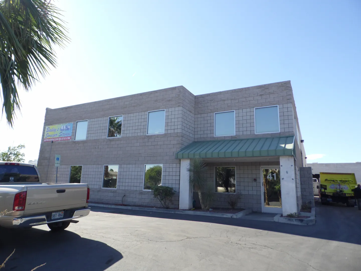 Exterior of the Bailey's Sweeper Service headquarters in Las Vegas with a branded banner on the wall