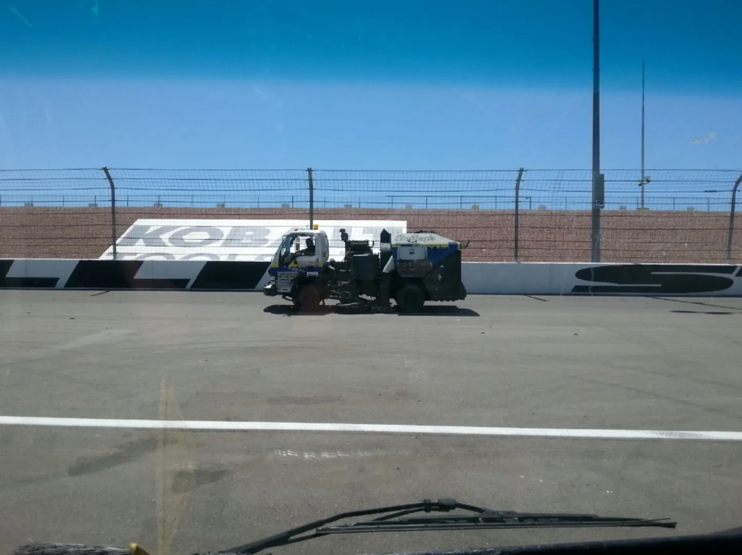 A Bailey's sweeper working the Las Vegas Motor Speedway track in front of the Kobalt Tools wall