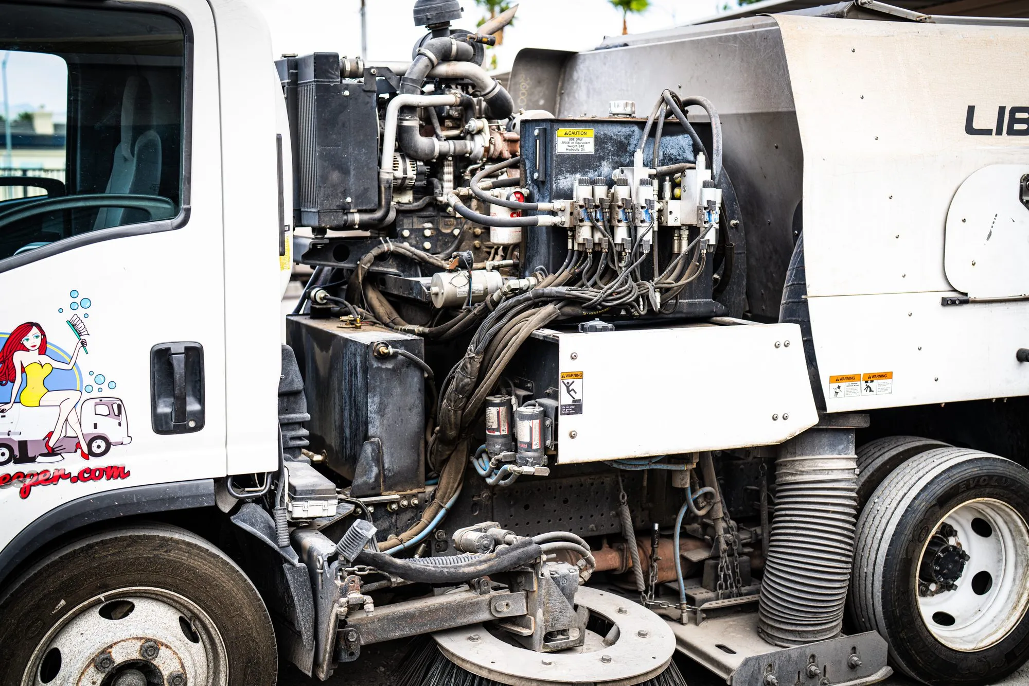 Close-up of the brushes and vacuum head on a Bailey's street sweeper