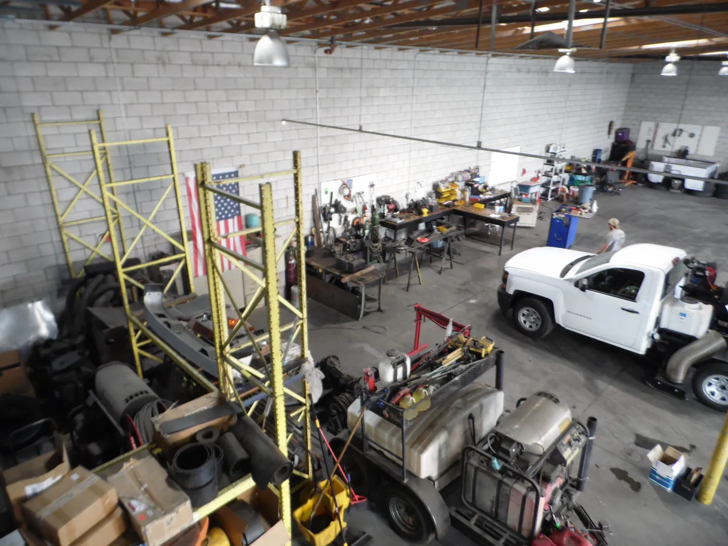 Overhead view of the Bailey's workshop with a white pickup truck, tools and equipment